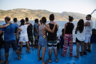 Passengers gazing at the island of Ikaria as the `Nissos Myconos` ferry is heading for the port of Pireus, Greece in August 18, 2017. Credit Aris Oikonomou SOOC